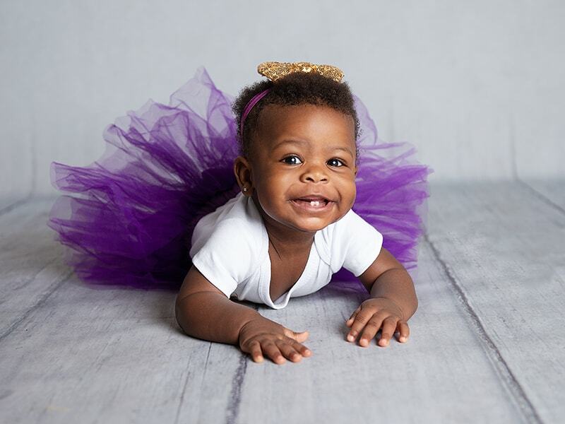 Baby Photoshoot in Memory Gate Photography studio in Croydon. Smiling baby on the tummy.