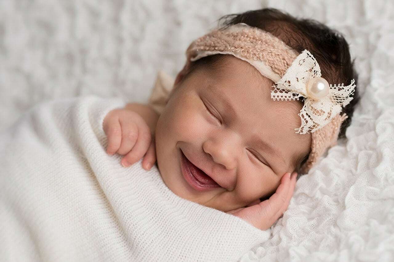 Why do newborn babies smile when they sleep?