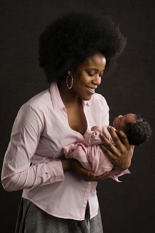 Mum with newborn baby. Photo on the dark brow background