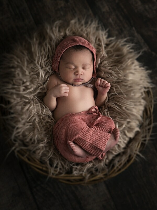 Newborn  in the basket. Photo taken in Corydon studio